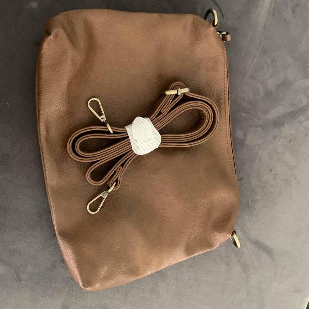 Camel / light brown leather clutch with purse strap. Never used, no tags.